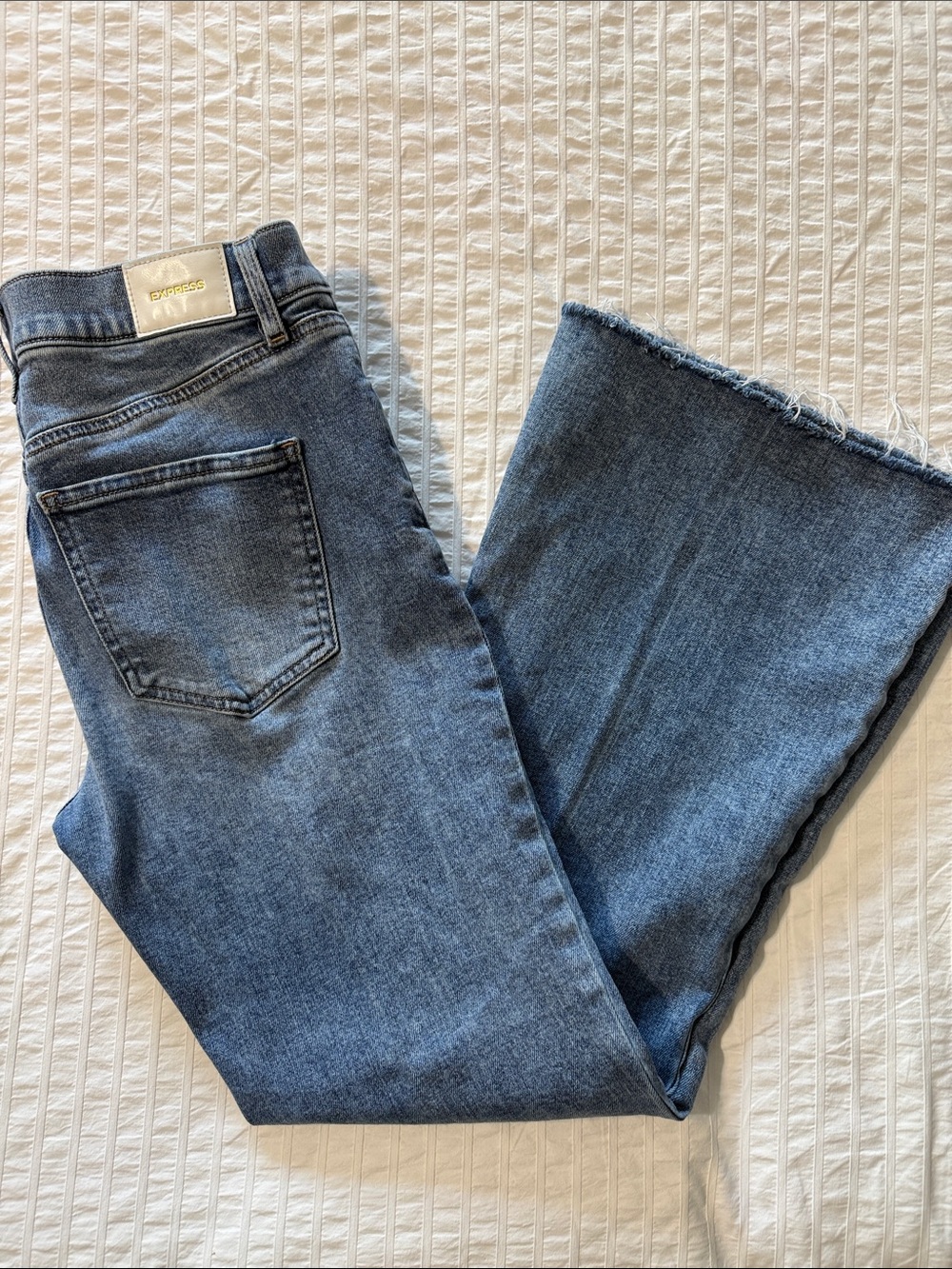 Express Women's Medium Blue Flared Jeans with Raw Hem